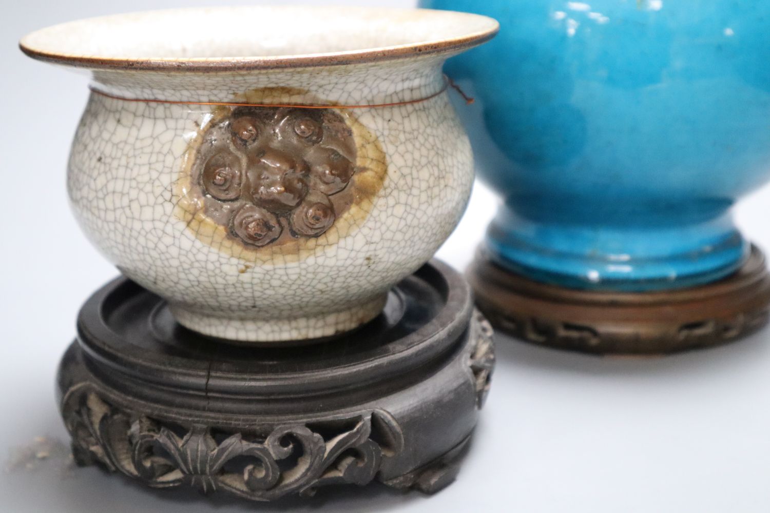 A 19th century Chinese crackleglaze squat bowl, with mask handles and a 19th century Chinese turquoise glazed baluster vase and two